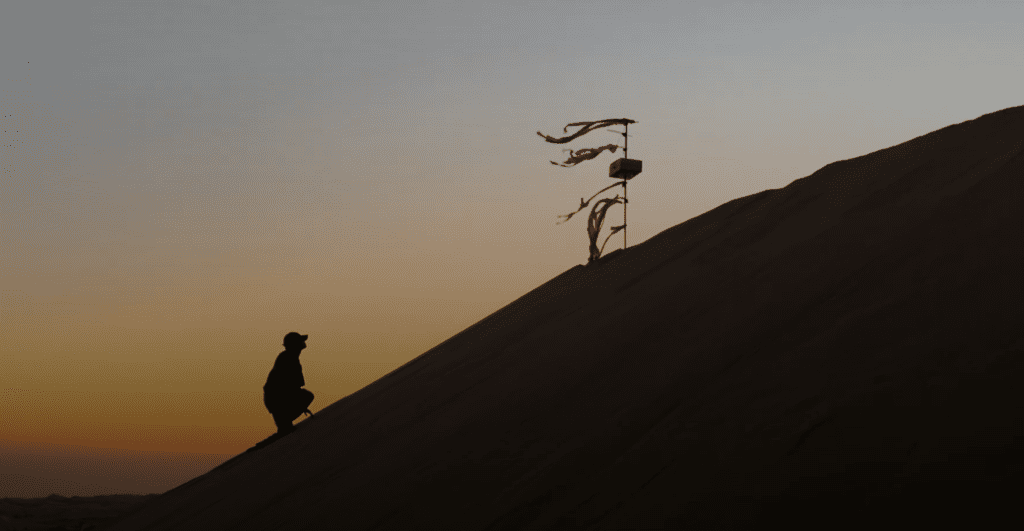 The hero photo: A man is reaching towards the spirit at sunset.